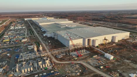 Drone-reveal-of-the-backside-of-Ford's-Megacampus,-BlueOval-City-at-Sunset-in-Stanton,-TN