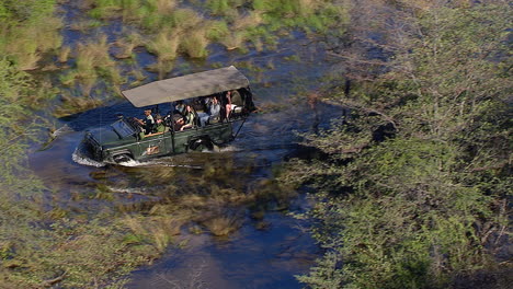 Driving-tourists-on-a-game-drive-through-the-swamps-of-the-Okavango-Delta