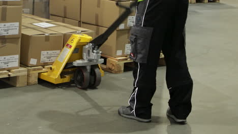 Logistics-warehouse-worker-using-forklift-to-take-boxes,-static-view
