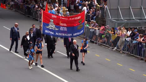 Representatives-from-101-Field-Battery-Association,-Royal-Australian-Artillery,-participate-in-Anzac-Day-parade-in-downtown-Brisbane,-honouring-those-who-served-and-sacrificed-amidst-cheering-crowds