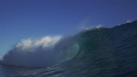 Strong-ocean-wave-crashes-white-wash-foam-in-closeout-to-view-of-backside-vortex-barrel