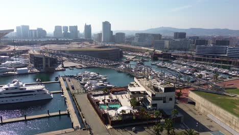 aerial-view-of-the-port-of-the-forum-in-Barcelona,-Spain-on-a-sunny-day-with-the-beautiful-city-in-the-background