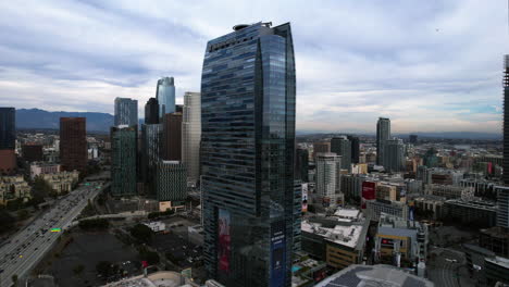 Los-Angeles-CA-USA,-Aerial-View-of-JW-Marriott-Los-Angeles-LA-LIVE-Hotel,-Downtown-Buildings-and-Highway-Traffic