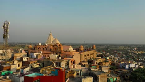 playing-holi-and-many-people-are-coming-to-visit-the-temple-and-many-are-cleaning-on-the-roof-fields-and-fields-are-visible-in-the-far-area-of-the-temple