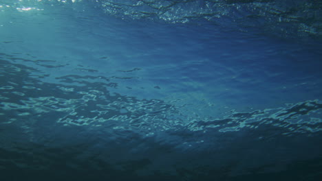 Mesmerizing-ocean-backside-of-wave-from-underwater-pan-across-as-it-breaks