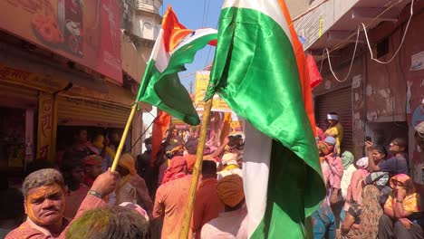 Los-Empleados-De-Dios-Están-Interpretando-A-Dhuleti-En-Primera-Persona-Con-Una-Bandera-Tricolor-Y-Una-Vestimenta-Diferente,-Y-Este-Holi-Está-Siendo-Fotografiado-Y-Grabado-Por-Humanos.