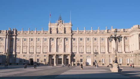 Courtyard-in-front-of-the-Madrid-Royal-Palace-,-the-official-home-of-the-King-of-Spain-and-the-largest-in-Western-Europe,-as-the-sunset-starts-to-settle-in