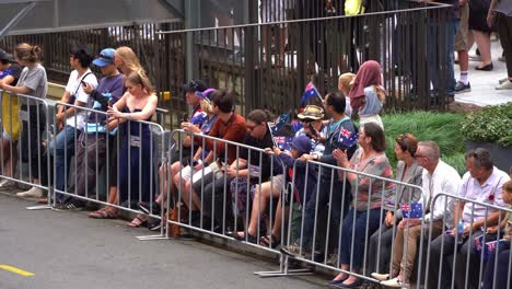 Crowds-of-Australian-citizens-gather-in-downtown-Brisbane-city,-swelling-with-anticipation-before-the-commencement-of-the-annual-tradition-Anzac-Day-parade-at-Anzac-Square,-close-up-shot