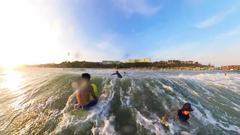 Young-Asian-Boy-In-Wetsuit-Surfing-Towards-The-Camera-And-Then-Wiping-Out-With-Surfboard-Flying-Into-The-Air