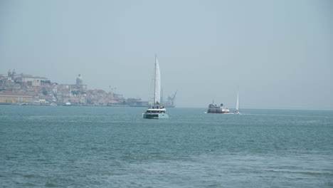 Segelboote-Und-Fähren-Fahren-Auf-Dem-Tejo-In-Lissabon
