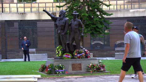 Statue-of-the-Korea,-Malaya,-Borneo-Memorial-at-Anzac-Square-Brisbane-city-adorned-with-flowers-and-wreaths