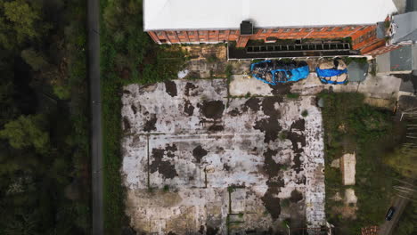 Abandoned-and-destroyed-commercial-building,-aerial-top-down-view