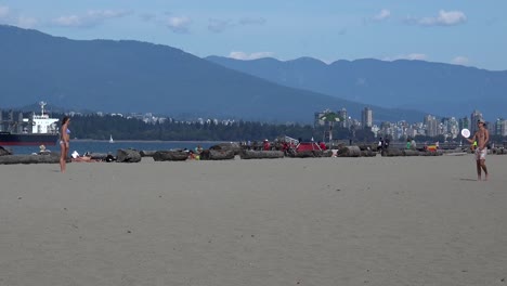 A-muscular-man-playing-frisbee-on-a-Vancouver-beach