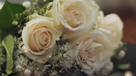 Closeup-of-beautiful-bouquet-of-white-roses-with-green-foliage-designed-for-a-wedding