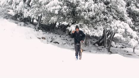 Old-Mooroccan-man-get-out-of-forest-with-his-ax-and-some-woods-in-snowy-weatherin