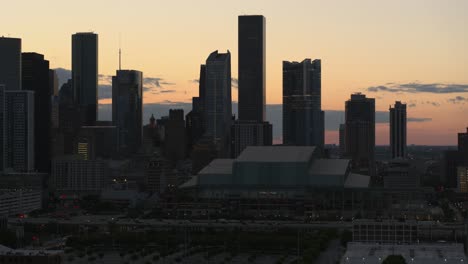 Drone-view-of-downtown-Houston,-Texas-during-sunset