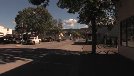 One-car-driving-on-quiet-street-in-small-town