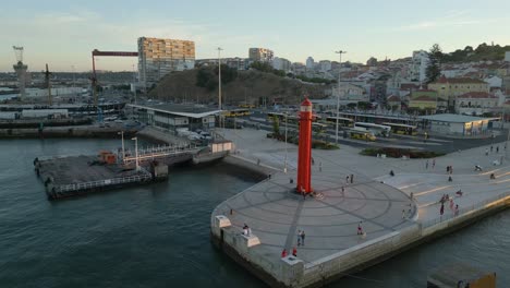 Drone---Arc-shot---Red-lighthouse-on-the-banks-of-river-Tagus-in-Lisbon,-Portugal