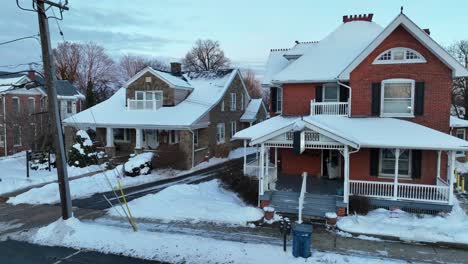 Snow-covered-home-and-buildings-in-small-American-neighborhood