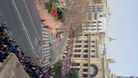 Falleras-with-typical-dresses-walking-in-the-town-hall-square-during-the-Fallas-festival-in-Valencia,-Spain