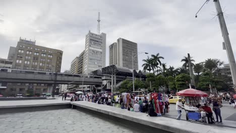 Local-people-and-tourists-gather-at-medellin-plaza-botero-colombia-streets-in-summer