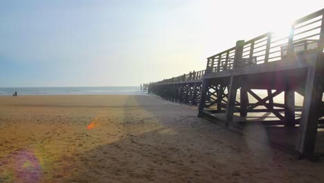 Side-view-of-the-wooden-pier-overlooking-the-beach-at-Vendee-in-France