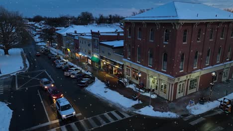 Soft-snowflakes-falling-from-dusk-sky-in-american-town-during-Christmas