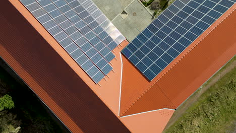Aerial-view-of-modern-solar-panels-installed-on-the-rooftops-of-houses,-harnessing-renewable-energy-from-the-sun