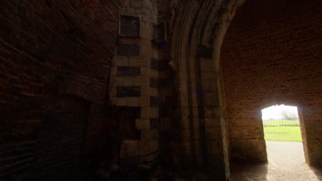 Tilting-mid-shot-inside-of-St-Benet’s-abbey-16th-century-gatehouse-with-18th-century-windmill