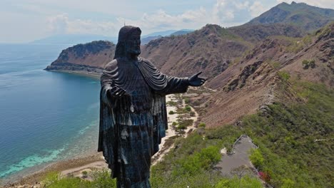 Cape-Fatucama,-Dili,-East-Timor---Cristo-Rei-of-Dili-Statue---Orbit-Drone-Shot