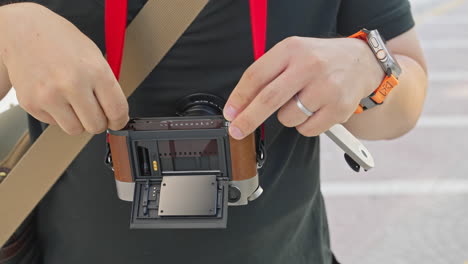 Photographer's-Hand-Loading-Film-into-Vintage-Camera