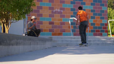 Skater-does-a-trick-on-a-ledge-while-his-friends-watch