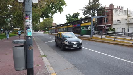 Hyperlapse-car-and-bus-traffic-at-Juan-b-Justo-Argentine-avenue-urban-park-buenos-aires-streets,-pedestrians-in-asphalted-way,-south-american-metropolitan-capital