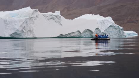 Tourists-in-Boat-Getting-Closer-to-Big-Iceberg-in-Cold-Water-of-Isfjord-Svalbard-Norway-60fps