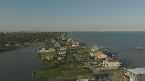 An-aerial-view-of-waterfront-homes-on-Todville-Road-and-Galveston-Bay-in-late-afternoon-in-Seabrook,-Texas