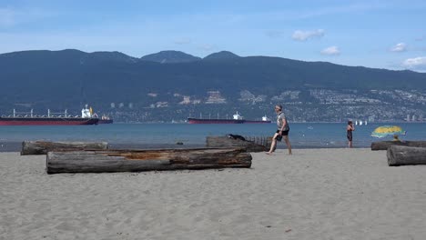 Two-women-talk-past-the-camera-on-a-Vancouver-beach