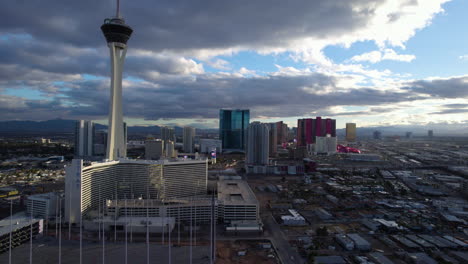 Las-Vegas-USA,-Aerial-View-of-The-Strat-and-Northern-Strip-Buildings-Under-Clouds-on-Sunset