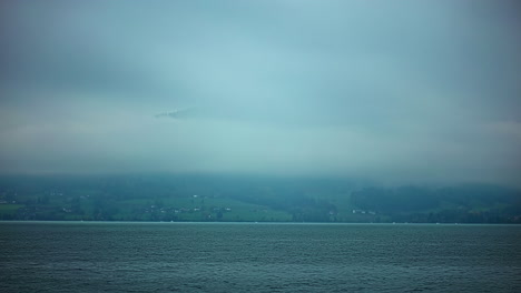 Time-Lapse,-Attersee-lake-Austrian-alps-mountain-background-misty-skyline-water-in-motion,-top-agricultural-village-skyline,-panoramic-landscape