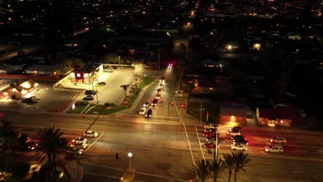 night-time-timelapse-of-busy-streets-bright-lights-commercial-building-in-San-Bernardino-California-Highway-10-Redlands-freeway-with-Costco-wholesale-in-view-AERIAL-DOLLY