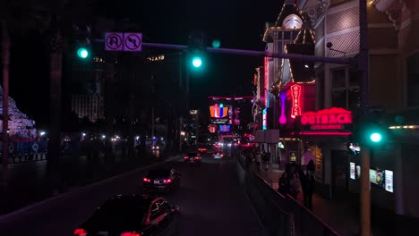 Driving-on-Las-Vegas-Strip-at-Night,-Traffic-and-Shiny-Lights-on-Buildings,-Point-of-View