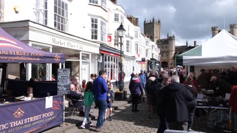 Menschen,-Die-An-Einem-Geschäftigen-Osterwochenende-In-Somerset,-Im-Südwesten-Englands,-In-Den-örtlichen-Einzelhandelsgeschäften-Und-An-Den-Verkaufsständen-Auf-Dem-Beliebten-Marktplatz-Von-Wells-Einkaufen