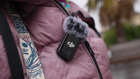 DJI-Wireless-Mic-2-With-Fluffy-Deadcat-On-Top-Attached-To-Pink-Jacket