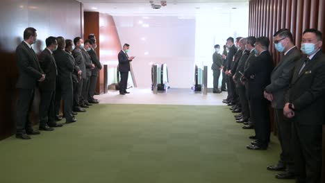 Numerous-security-guards-stand-on-both-sides-of-the-hallway-as-they-wait-for-the-chief-executive-to-arrive-at-the-Hong-Kong-Legislative-Council-building-in-Hong-Kong