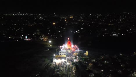 Aerial-drone-view-moving-upwards-and-behind-fire-breaks-and-lighting-show-is-visible