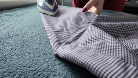 Ironing-a-shirt-sleeve,-at-home