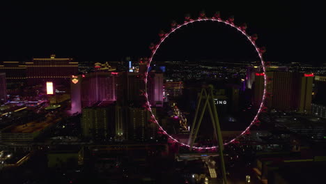 Las-Vegas-USA-at-Night,-Aerial-View-of-High-Roller-Ferris-Wheel-and-Strip-Buildings-in-Lights