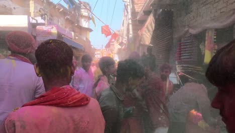 pov-shot-Many-people-are-playing-holi-in-the-bazaar-and-selling-different-dhuleti-items-like-picchkari-and-color-and-the-bazaar-is-decorated-with-kites