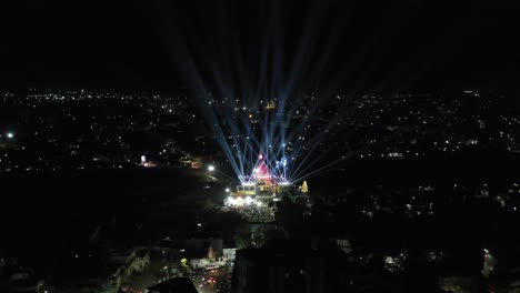 Aerial-drone-view-is-going-backwards-and-light-show-is-going-on-over-the-temple-of-Mahadev