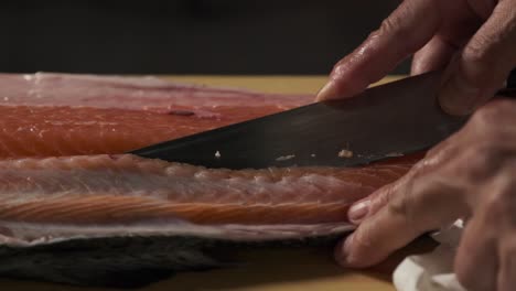 Chef-preparing-fresh-salmon-in-the-kitchen