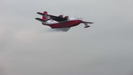 The-famous-Martin-Mars-water-bomber-in-action-in-Vancouver-Harbour,-doing-a-water-drop